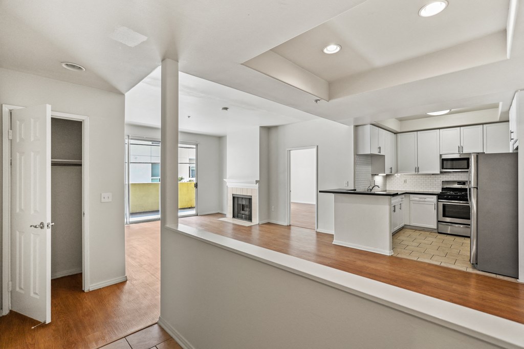 Front Entrance with Hall Closet, Dining Room, and Kitchen