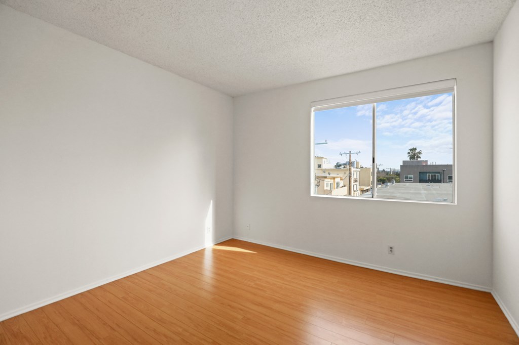 Bedroom with Vinyl Flooring and Large Windows