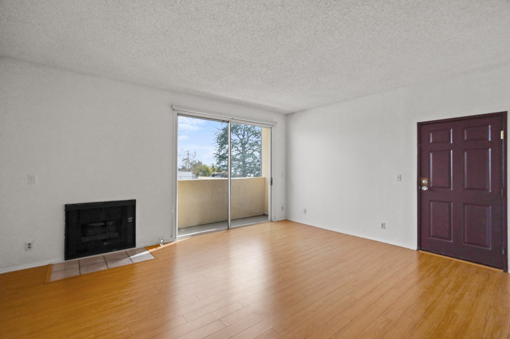 Front Entrance and Living Room Area with Fireplace and Balcony
