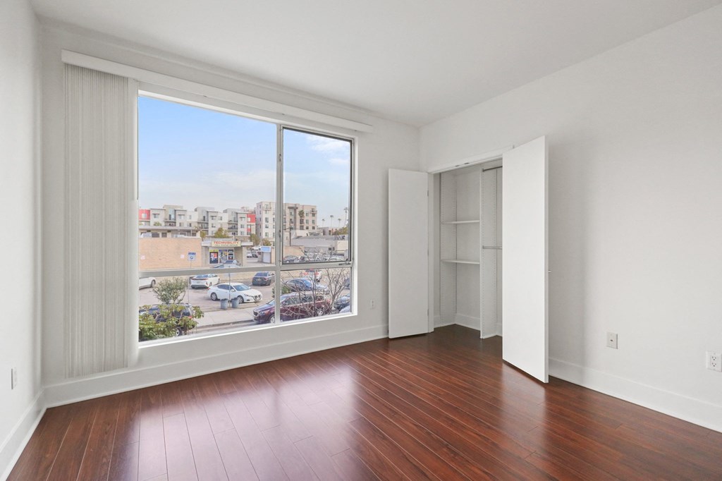 Bedroom with Closet, Vinyl Flooring, and Large-Size Windows