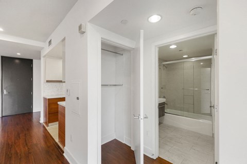 Hall Closet and Bathroom with a Bathtub