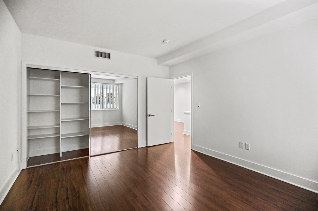 Bedroom with Closet with Built-In Shelving