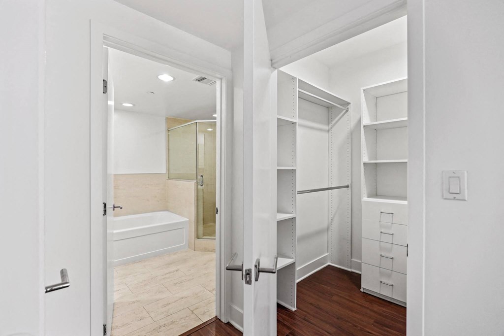 Walk-In Closet and Bathroom with a Full-Size Bathtub and a Walk-In Shower