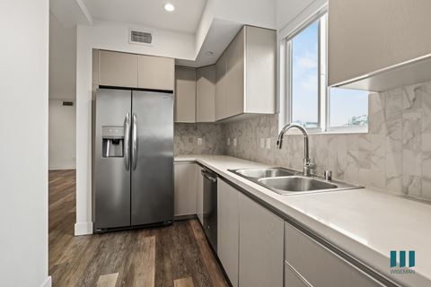 Kitchen with Stainless-Steel Refrigerator, Dishwasher, Stove, and Microwave Oven