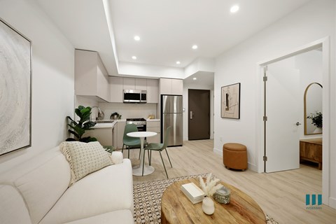 A modern living room with a white sofa and a wooden coffee table.