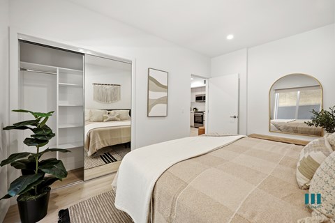 Bedroom with a Mirrored Closet and Built-In Shelving