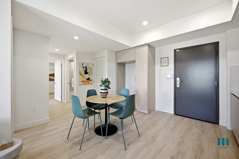 A dining room with a round table and chairs.