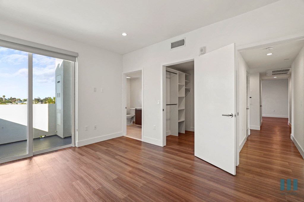Bedroom with Bathroom, Walk-In Closet, and Patio