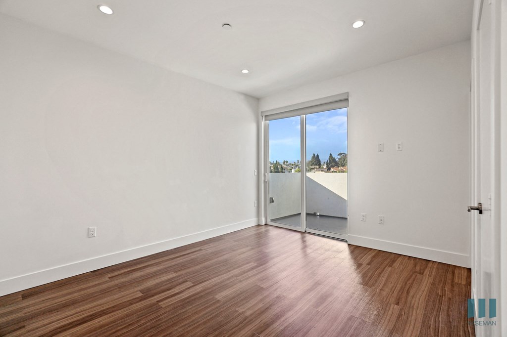 Living Room with Vinyl Flooring, Recessed Lighting, and Patio