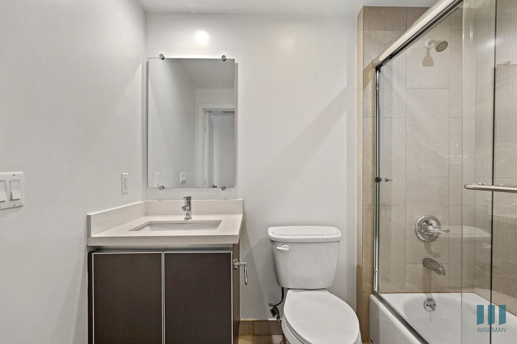 Bathroom with Shower Bath with Glass Door and Vanity Cabinet Storage