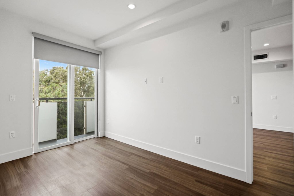 Bedroom with Recessed Lighting, Vinyl Flooring, and Balcony