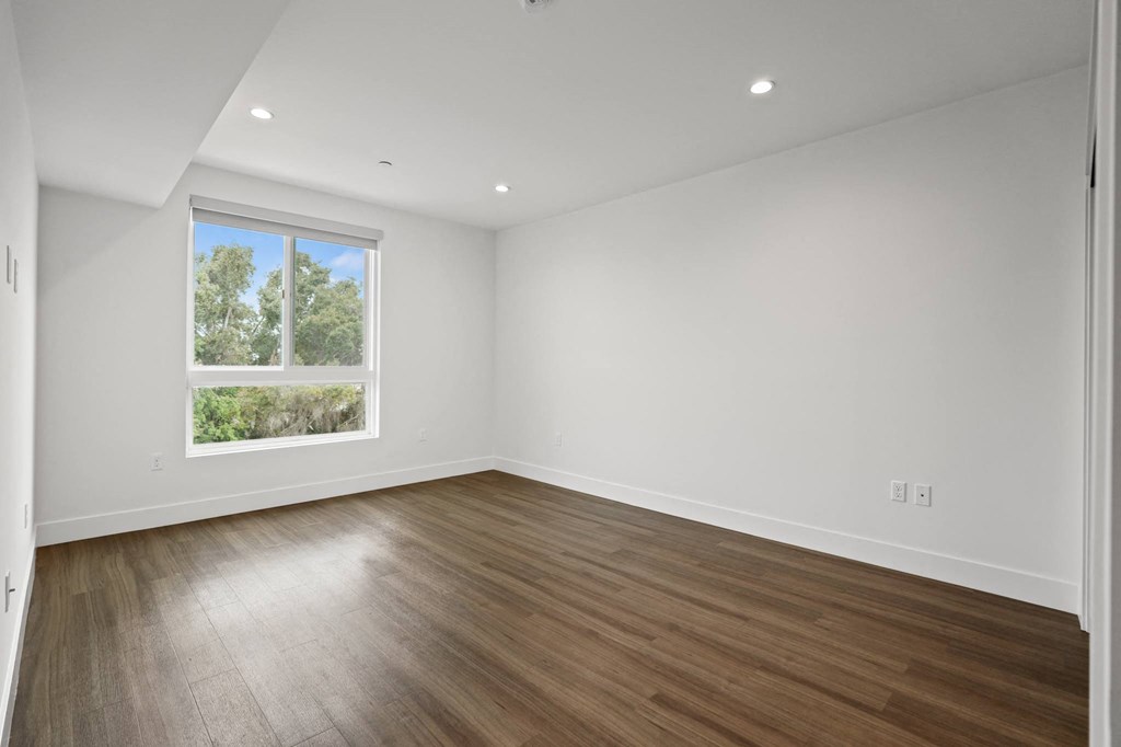 Spacious Bedroom with Recessed Lighting, Vinyl Flooring, And Large Windows