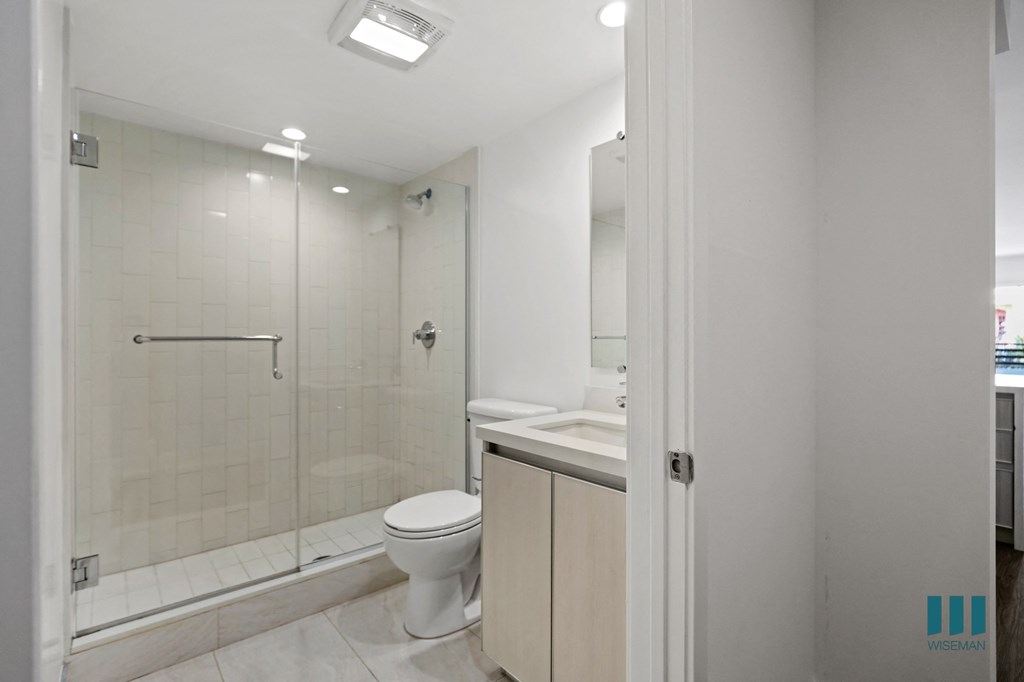 Bathroom with Walk-In Shower and Glass Door and Vanity Cabinet Storage