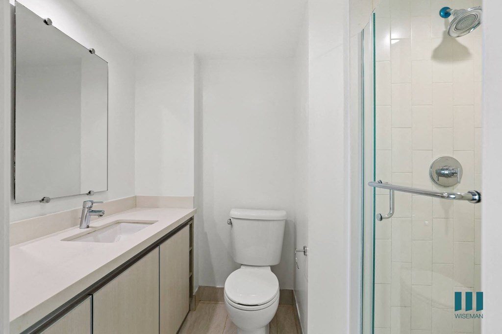 Bathroom with Stand-Up Shower with Glass Door and Vanity Cabinet Storage