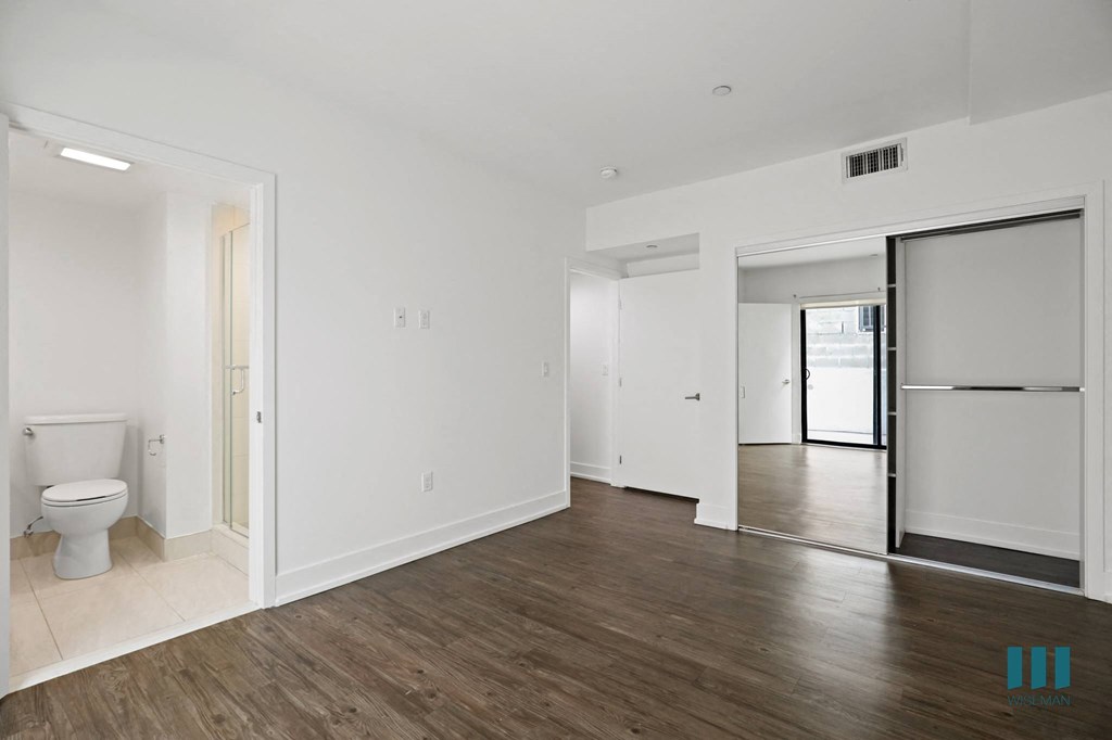 Bedroom with Mirrored Closet, Vinyl Flooring, Recessed Lighting, and Bathroom