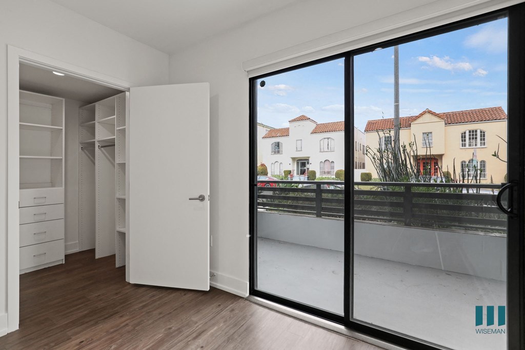 Bedroom with Walk-In Closet and Balcony Access