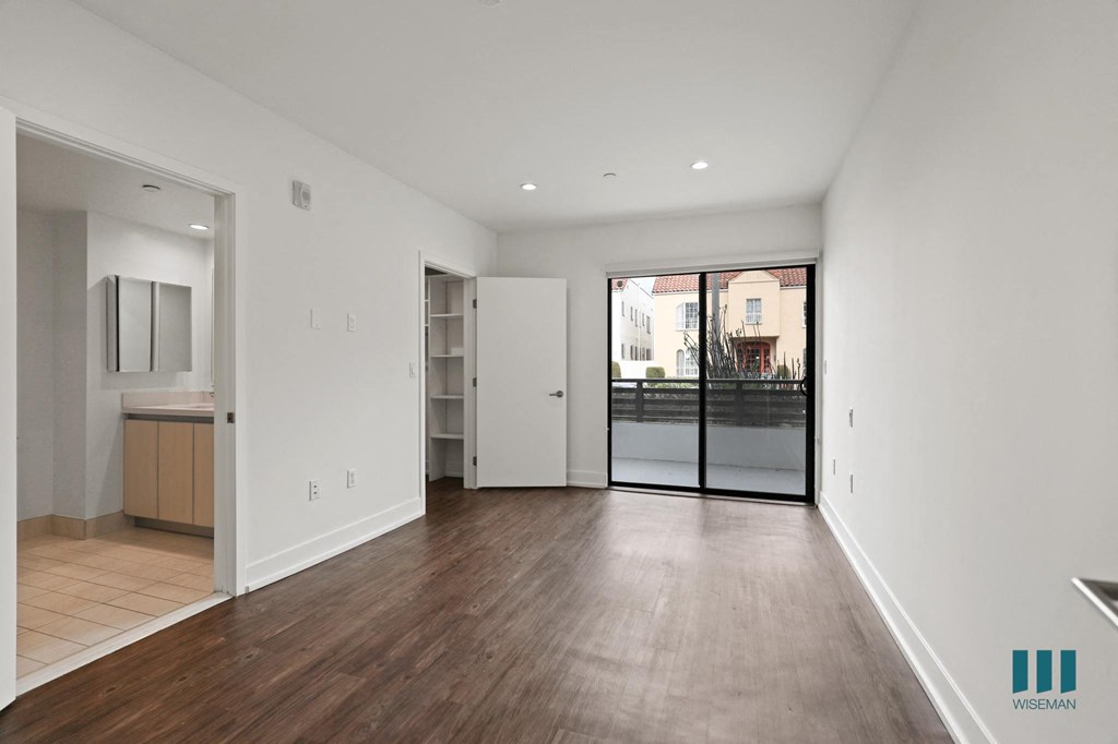 Bedroom with Walk-In Closet, Bathroom, and Balcony Access