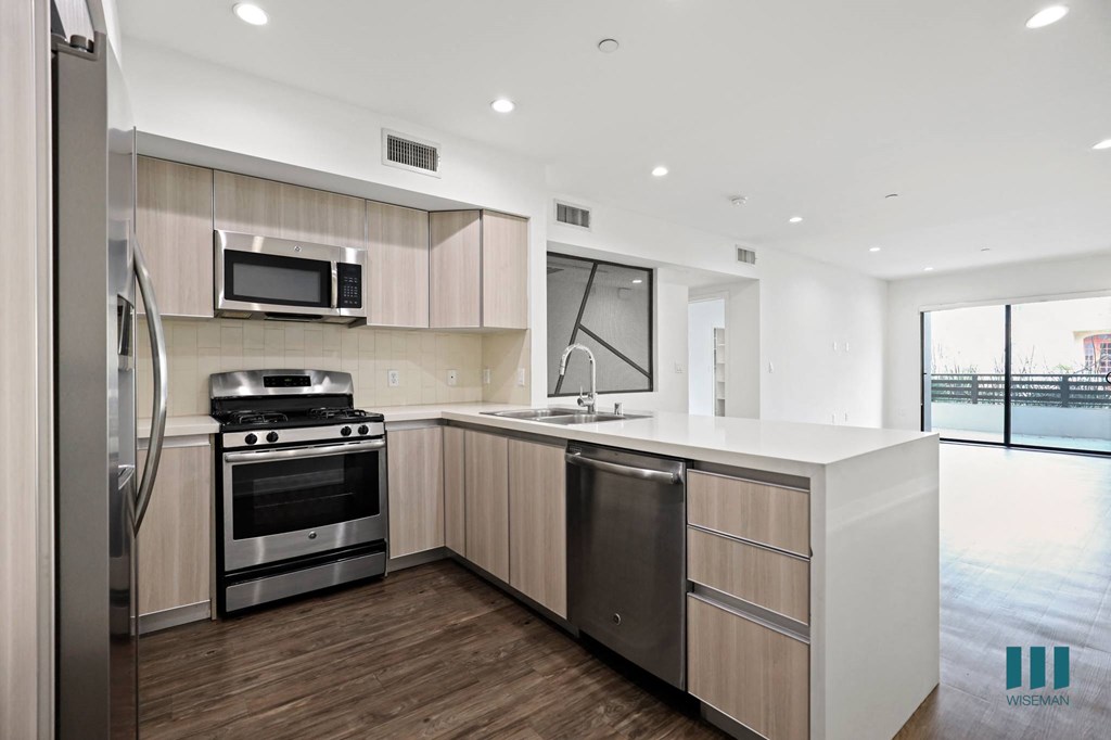 Kitchen with Energy-Efficient Stainless Appliances and Countertop Bar