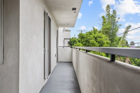 a long balcony with a door on the side of a building