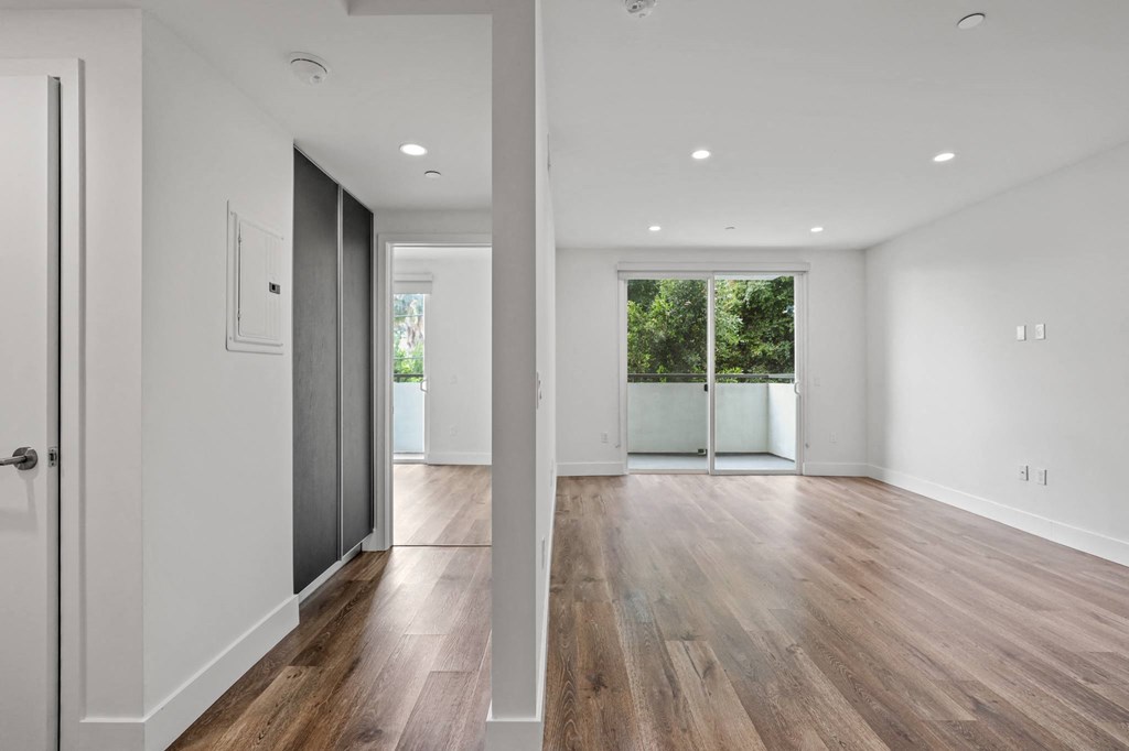 Hallway with Built-In Cabinet Storage and Living Room with Patio