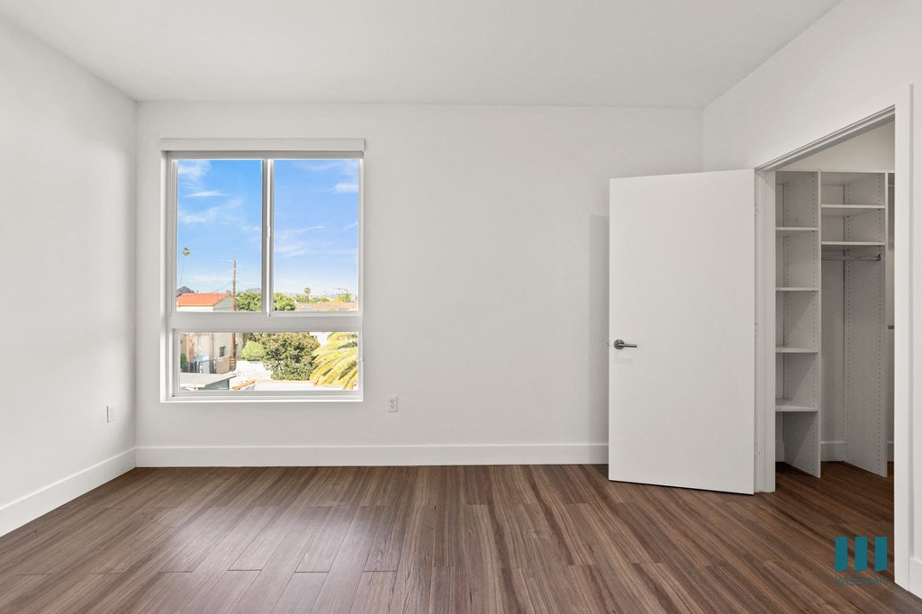Bedroom with Walk-In Closet with Built-In Organizers and Large-Size Windows