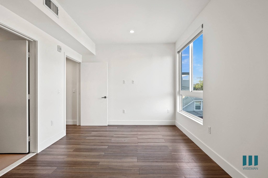 Bedroom with Vinyl Flooring, Bathroom, and Large Windows