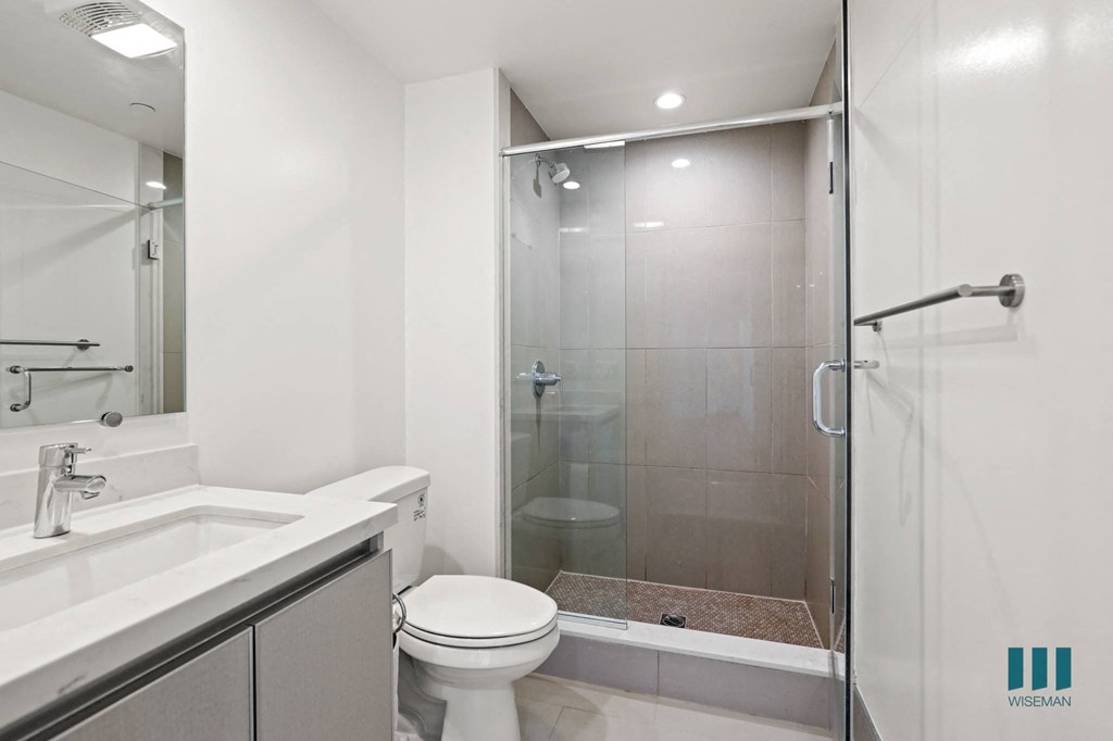 Bathroom with Stand-In Shower and Glass Door and Vanity Cabinet Storage