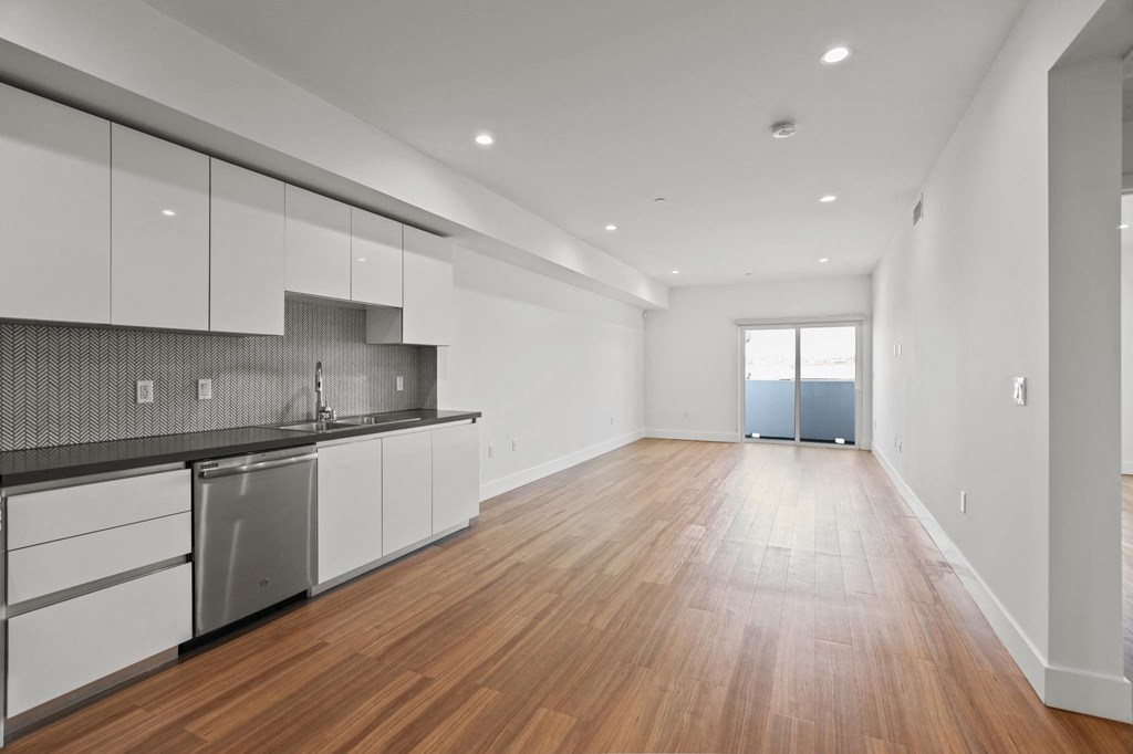 Open-Concept Kitchen, Dining, and Living Room Space with Patio