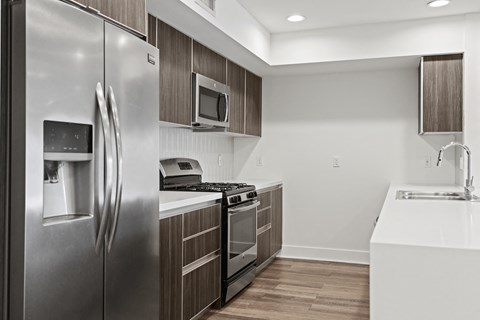 a kitchen with stainless steel appliances and wooden cabinets