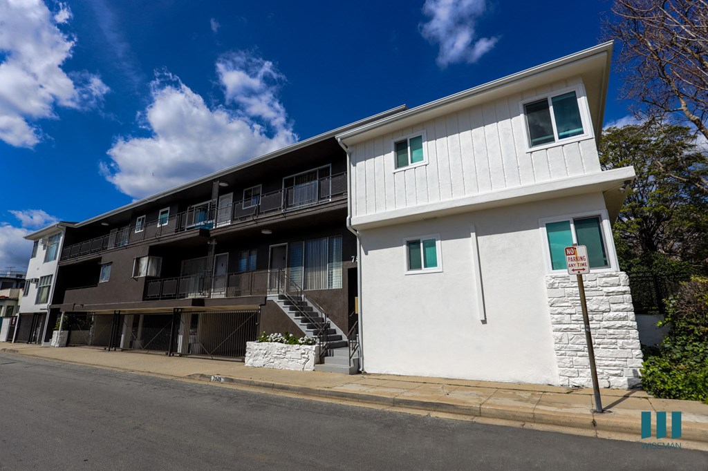 an apartment building on the corner of a street