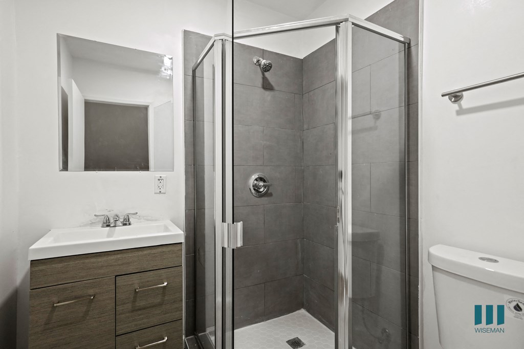 Bathroom with Stand-Up Shower with Glass Door and Vanity Cabinet Storage