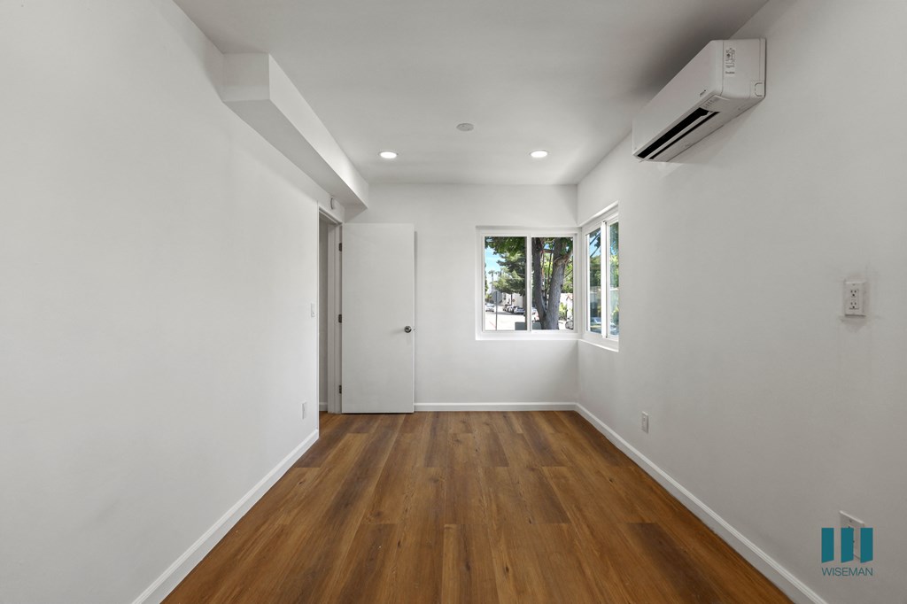 Bedroom with Multiple Windows, Vinyl Flooring, and Recessed Lighting