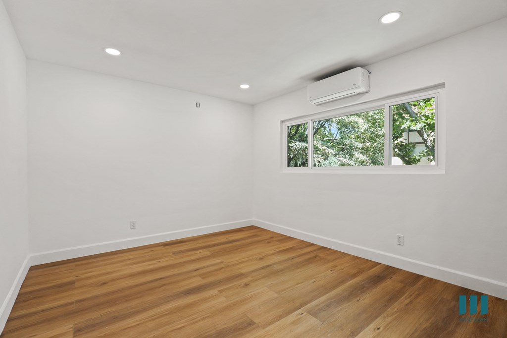 Bedroom with Large-Size Windows, Recessed Lighting, and Vinyl Flooring