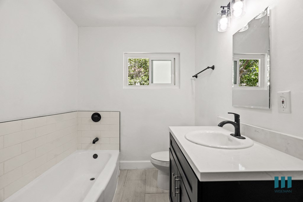 Bathroom with Bathtub, Windows, and Vanity Cabinet Storage