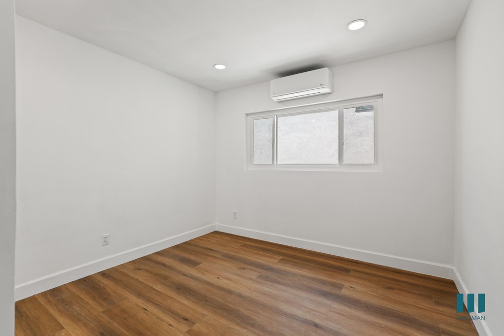Bedroom with Vinyl Flooring, Recessed Lighting, and Window
