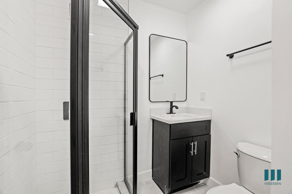 Bathroom with Walk-In Shower with Glass Door and Vanity Cabinet Storage