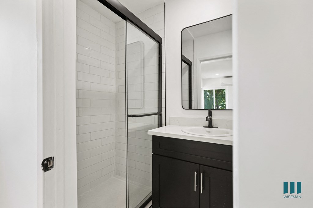 Bathroom with Bathtub, Windows, and Vanity Cabinet Storage