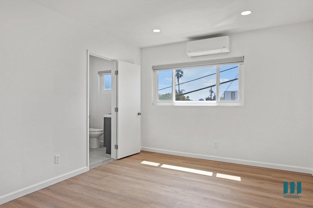 Bedroom with Vinyl Flooring, Windows, and Bathroom