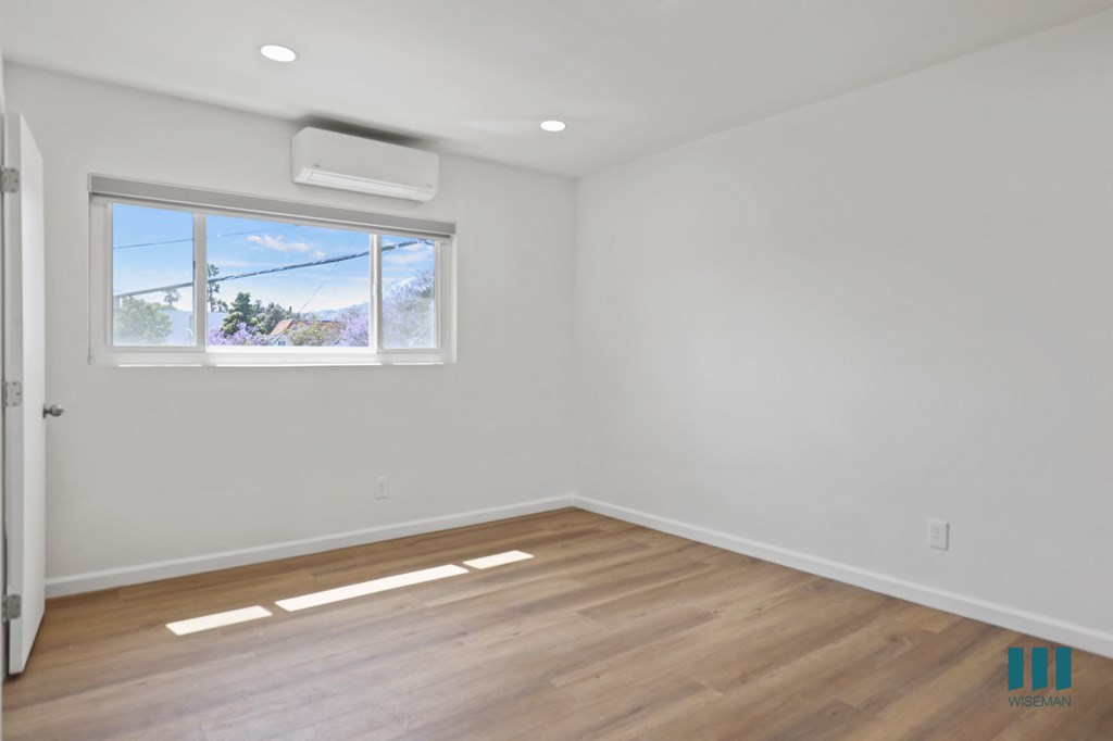 Bedroom with Windows, Vinyl Flooring, and Recessed Lighting