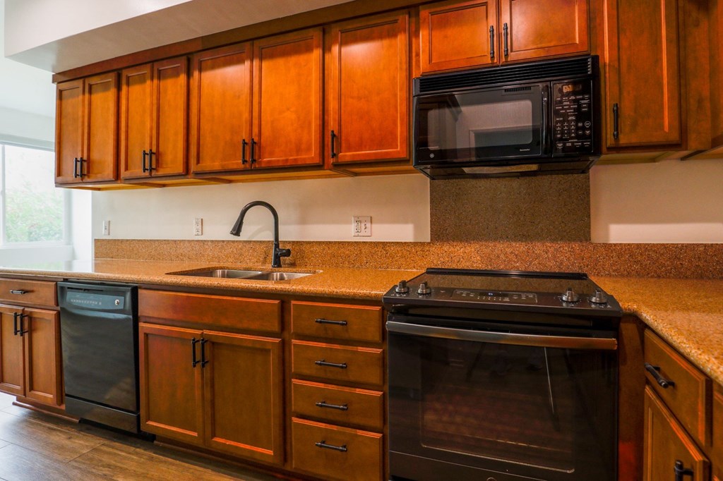 Kitchen with Dishwasher, Stove, and Microwave Oven