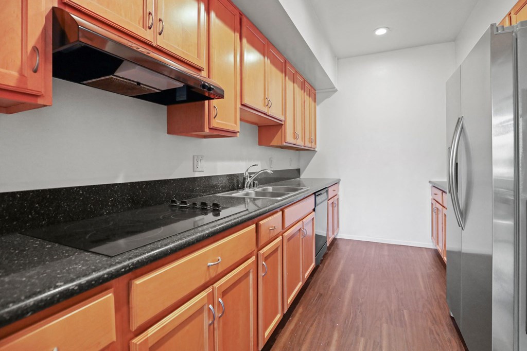 Kitchen with Cooktop, Dishwasher, and Refrigerator