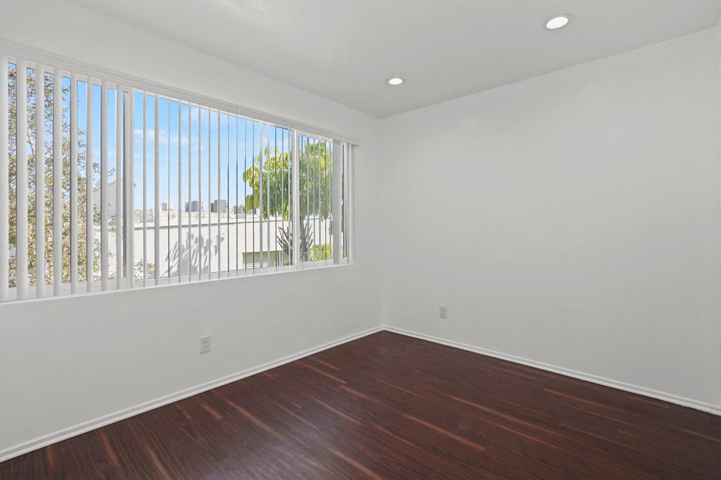 Bedroom with Large Window, Recessed Lighting, and Vinyl Flooring