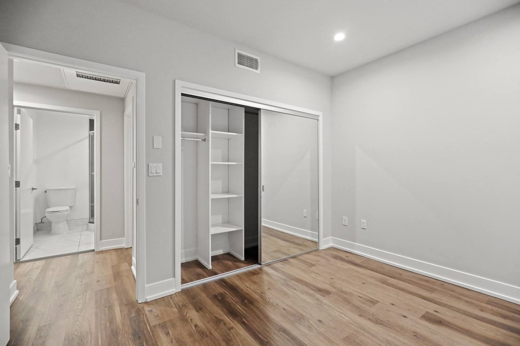 Bedroom with Mirrored Closet with Shelving