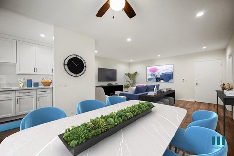 a dining room with a white table and blue chairs