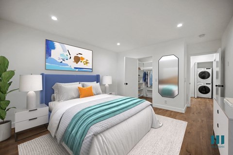 a bedroom with a blue and white bed and a mirror