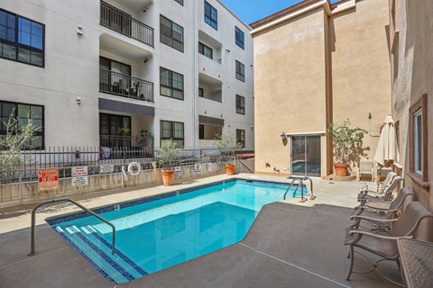 our apartments have a swimming pool and a patio with chairs