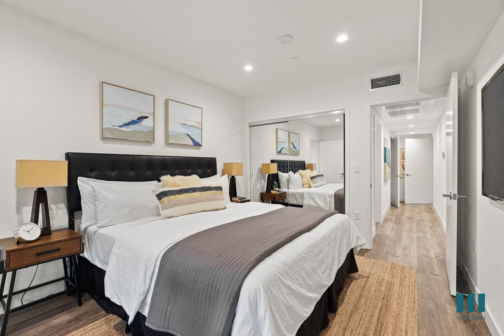 Bedroom with Mirrored Closet, Vinyl Flooring, and Recessed Lighting