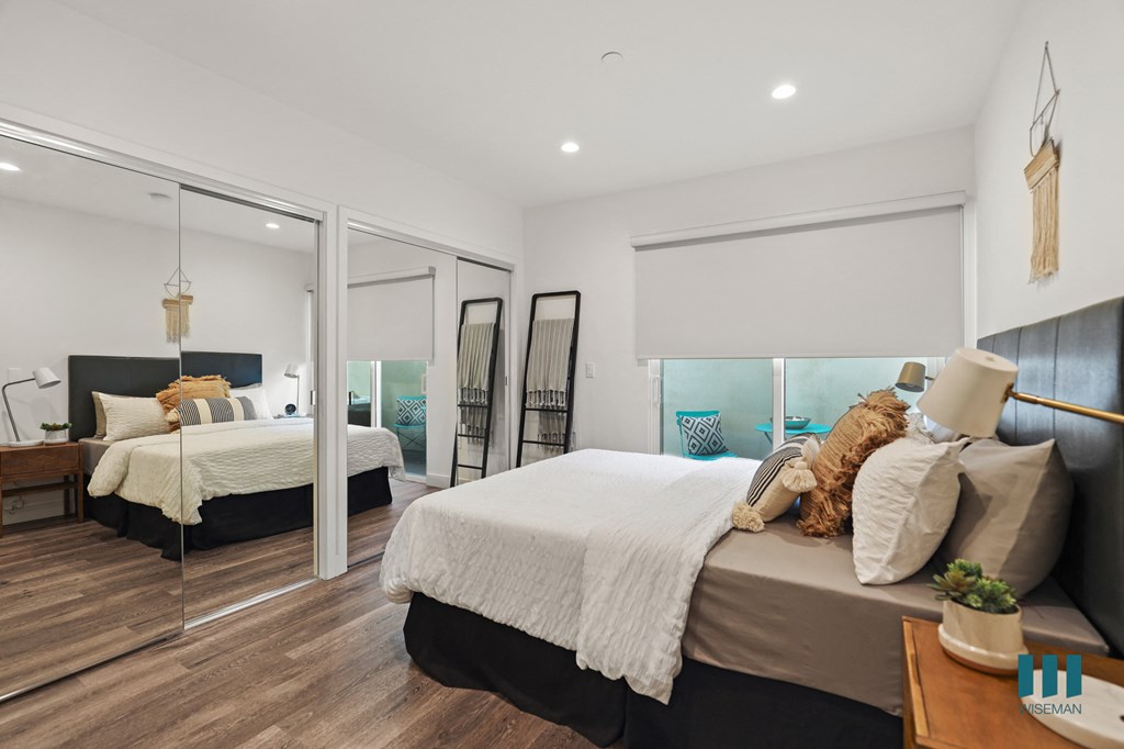 Bedroom with Two Mirrored Closets, Vinyl Flooring, Recessed Lighting, and Private Entrance