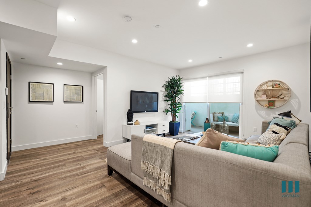 Front Entrance and Living Room with Sliding Glass Doors to Balcony