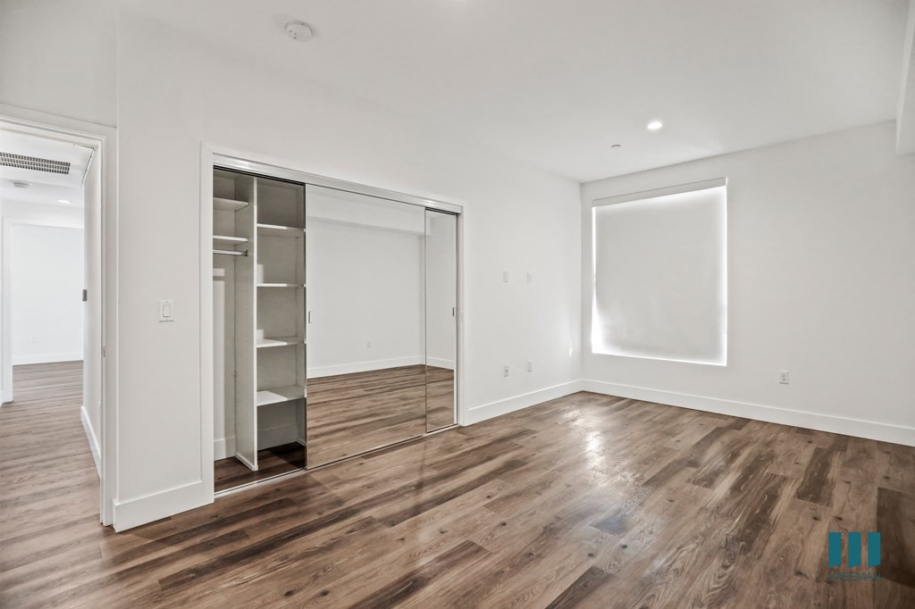 Bedroom with Mirrored Closet, Vinyl Flooring, Recessed Lighting and Large-Size Window